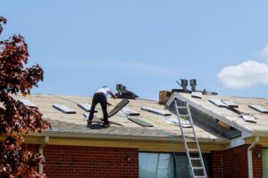 roofers replacing damaged roof